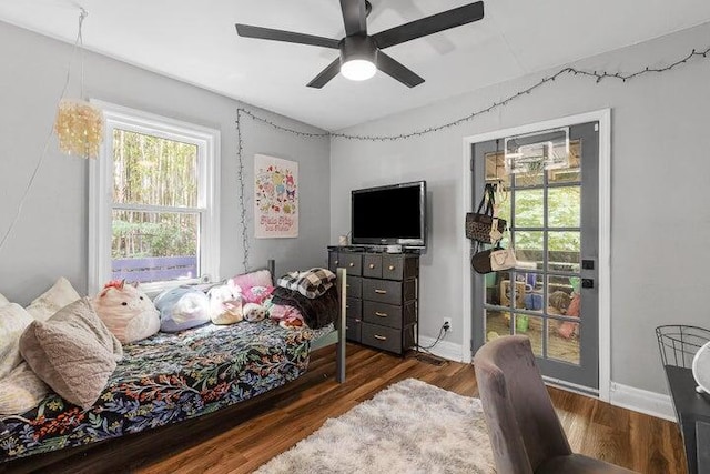 bedroom with dark hardwood / wood-style floors and ceiling fan