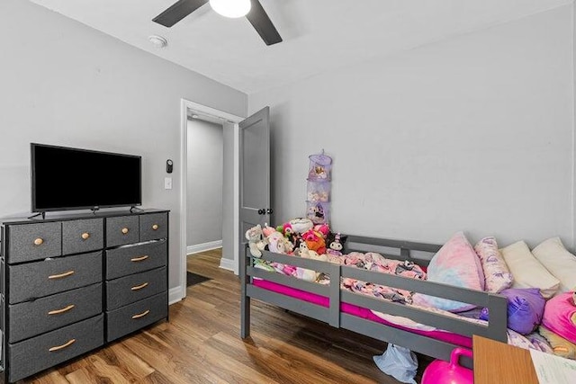 bedroom featuring ceiling fan and dark hardwood / wood-style floors