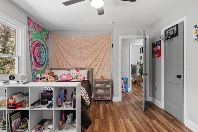 bedroom with ceiling fan and dark wood-type flooring