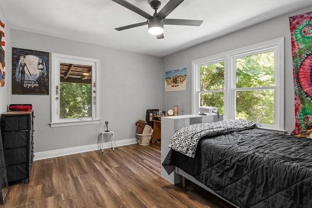 bedroom with dark hardwood / wood-style floors and ceiling fan