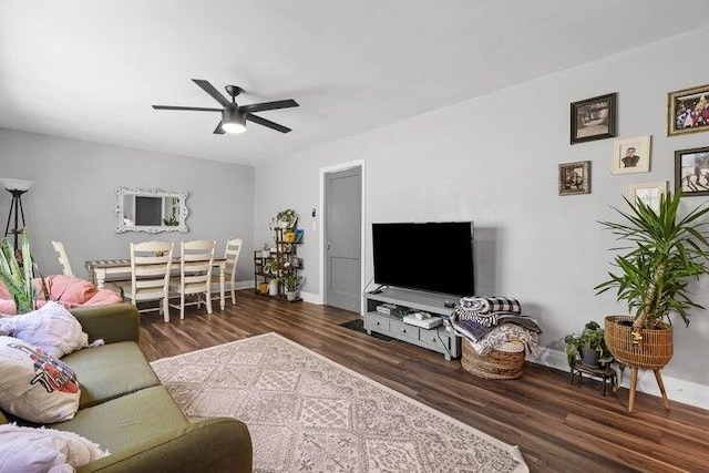 living room featuring dark hardwood / wood-style flooring and ceiling fan