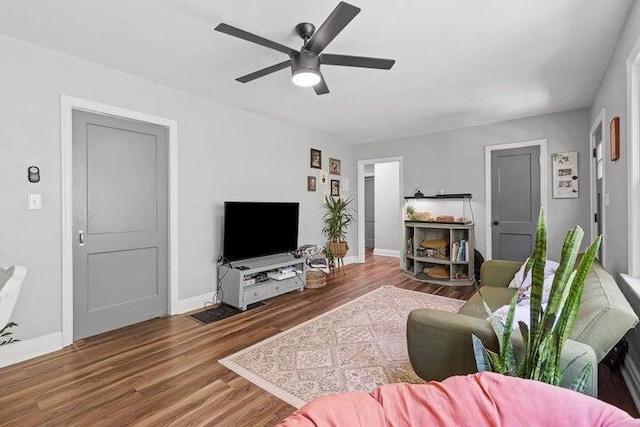 living room featuring ceiling fan and hardwood / wood-style floors