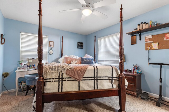 bedroom with light colored carpet, multiple windows, and ceiling fan