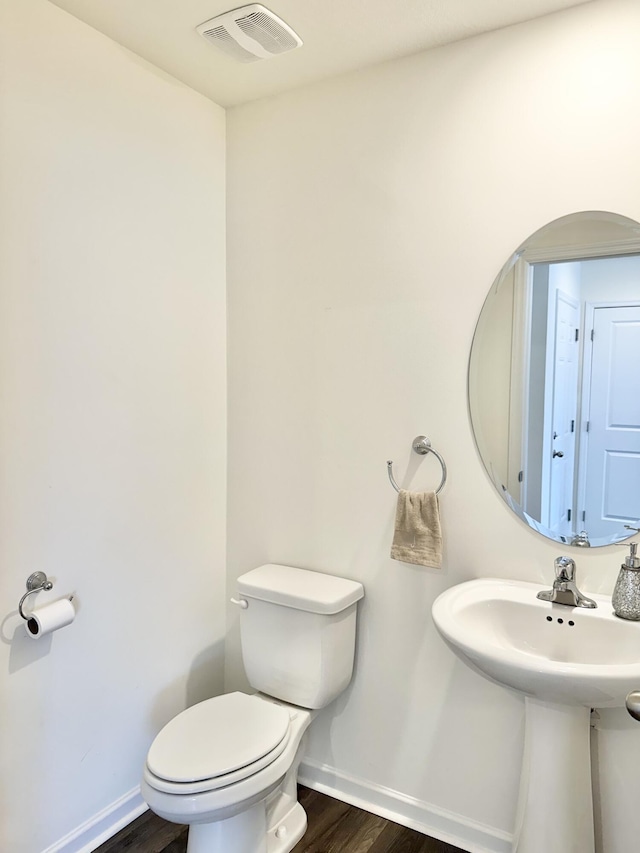 119 Lindsell Rd, Athens, TN 37303 - half bath with wood finished floors, visible vents, toilet, a sink, and baseboards