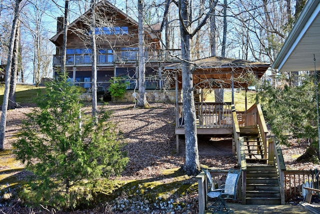 exterior space with stairway and a wooden deck