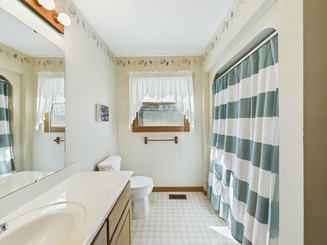 bathroom featuring baseboards, visible vents, toilet, tile patterned floors, and vanity