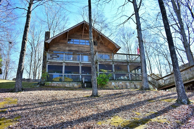 back of property with a chimney