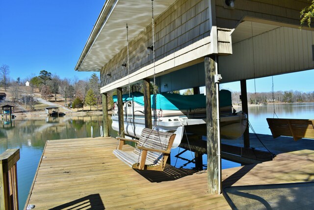 dock area with a water view and boat lift