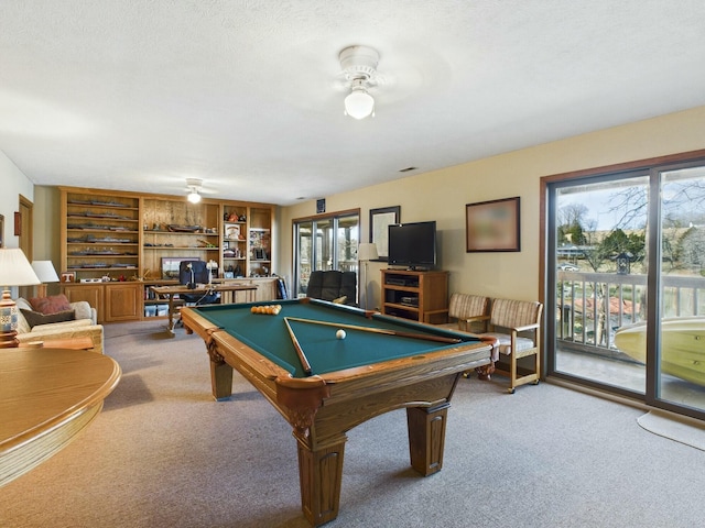 recreation room featuring a textured ceiling, carpet floors, pool table, and ceiling fan