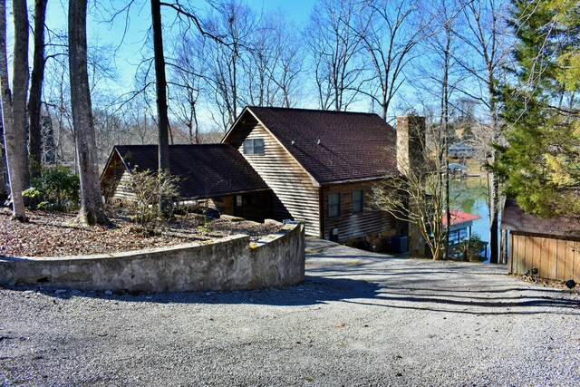 exterior space featuring driveway and a chimney