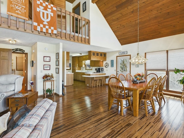 dining space with dark wood-type flooring, wooden ceiling, a high ceiling, and a notable chandelier