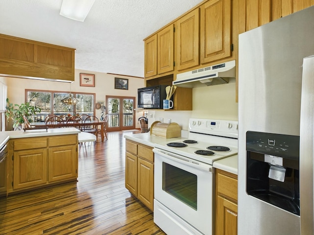 kitchen featuring white range with electric cooktop, light countertops, black microwave, stainless steel fridge, and under cabinet range hood