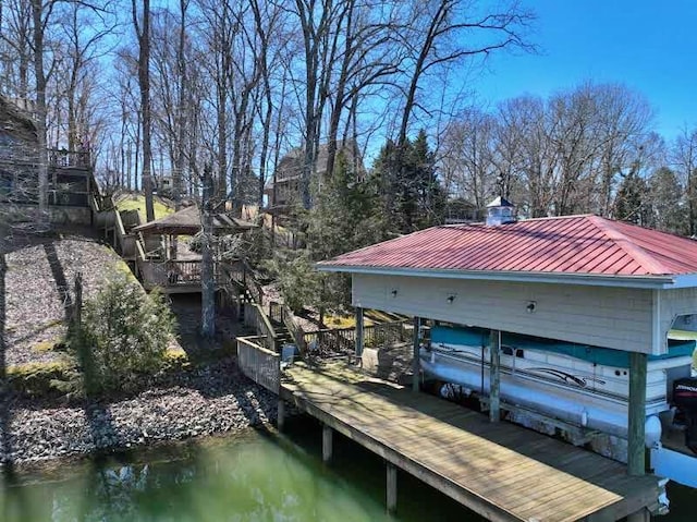 view of dock with a water view and boat lift