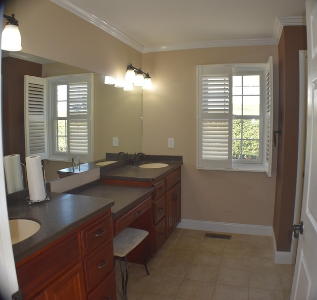 full bath with visible vents, ornamental molding, a sink, double vanity, and baseboards