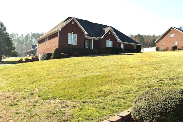 view of front of house featuring a front yard and brick siding