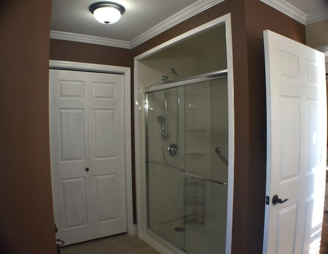 bathroom with a shower stall and crown molding