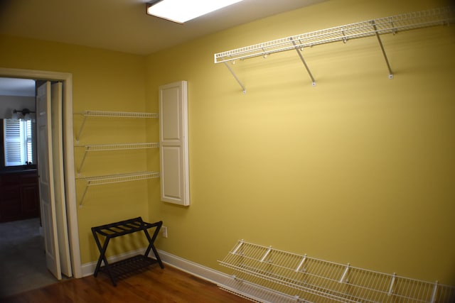 walk in closet featuring dark wood-type flooring