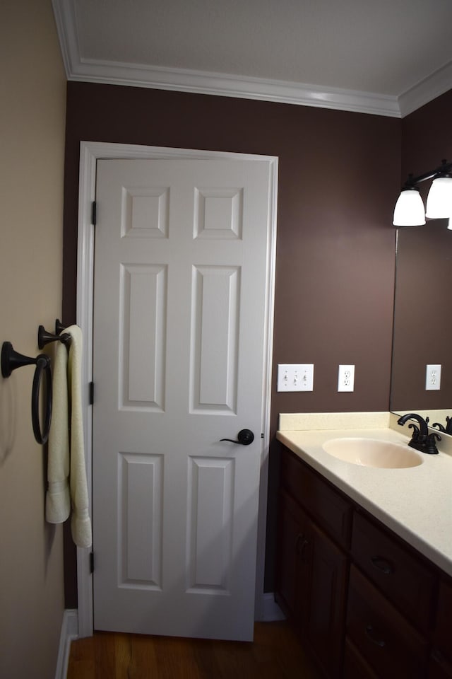 bathroom featuring vanity and ornamental molding