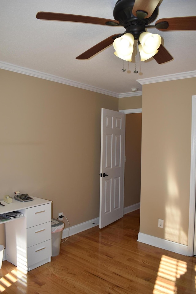 unfurnished bedroom with ceiling fan, baseboards, ornamental molding, and light wood finished floors