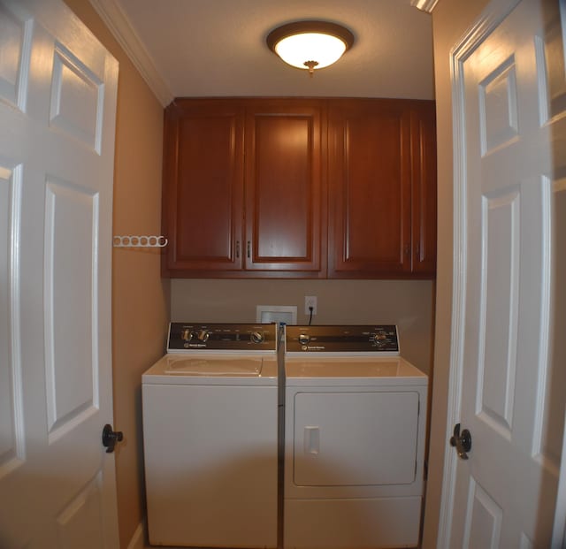 laundry room featuring washer and clothes dryer and cabinet space