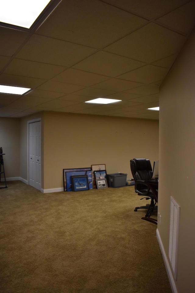 unfurnished office featuring visible vents, a paneled ceiling, carpet, and baseboards