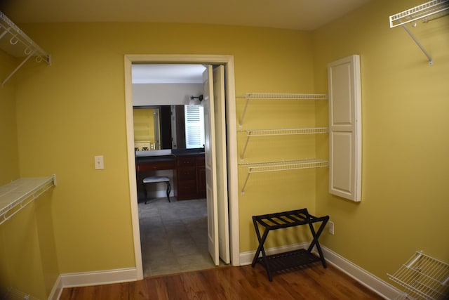 walk in closet featuring wood finished floors