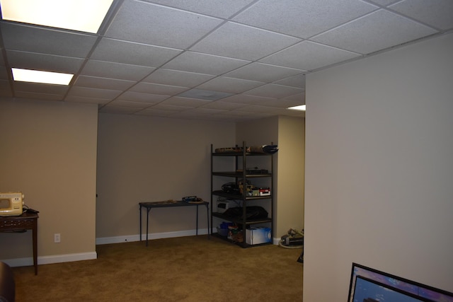 basement featuring carpet, baseboards, and a drop ceiling