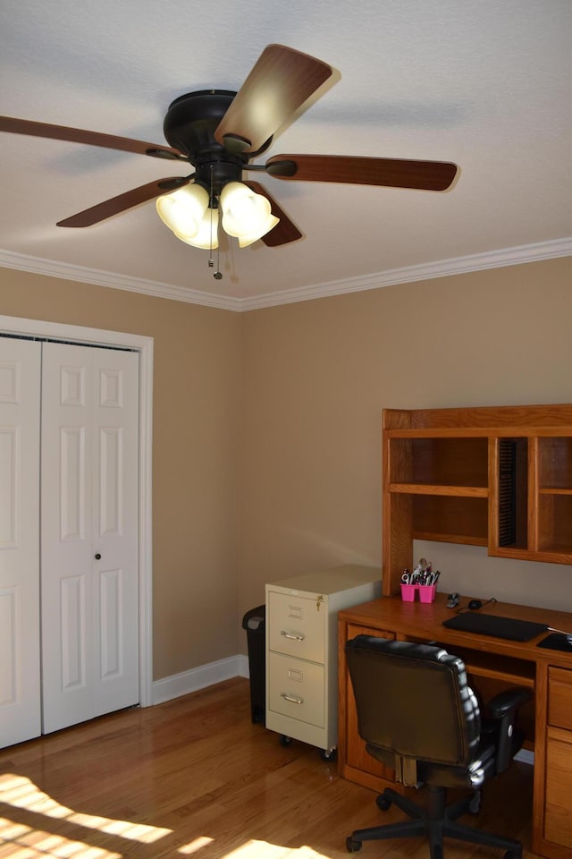 home office featuring ceiling fan, wood finished floors, baseboards, and ornamental molding