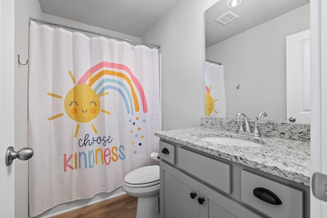 bathroom featuring hardwood / wood-style flooring, vanity, curtained shower, and toilet