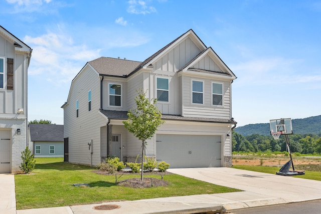 craftsman-style home featuring a mountain view, a garage, and a front lawn