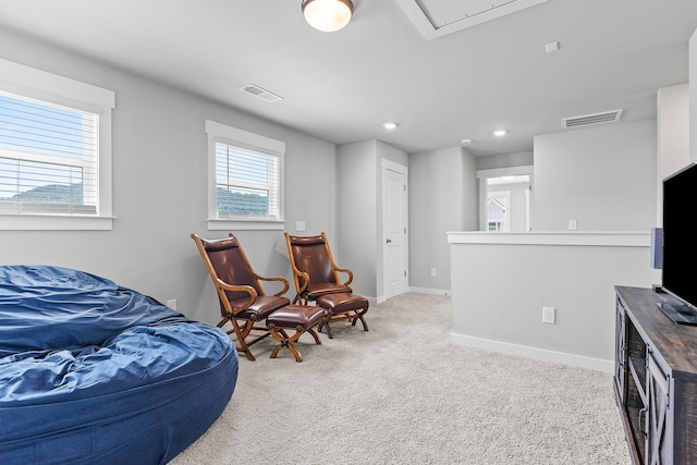 living area with light colored carpet