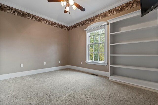 unfurnished room with ceiling fan, crown molding, and carpet