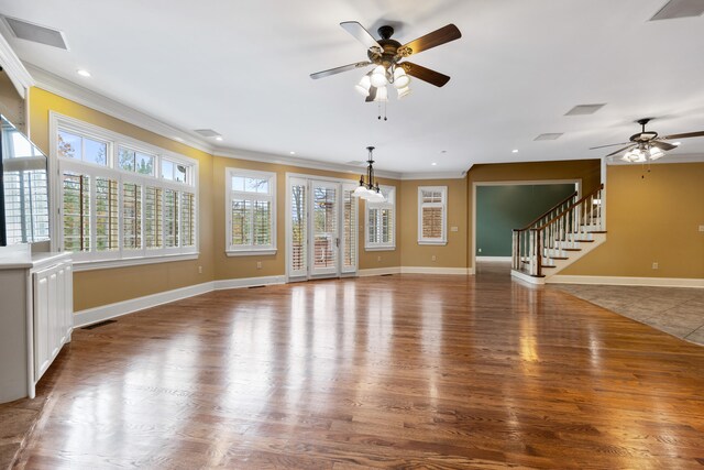 unfurnished living room with ceiling fan, dark wood-type flooring, and ornamental molding