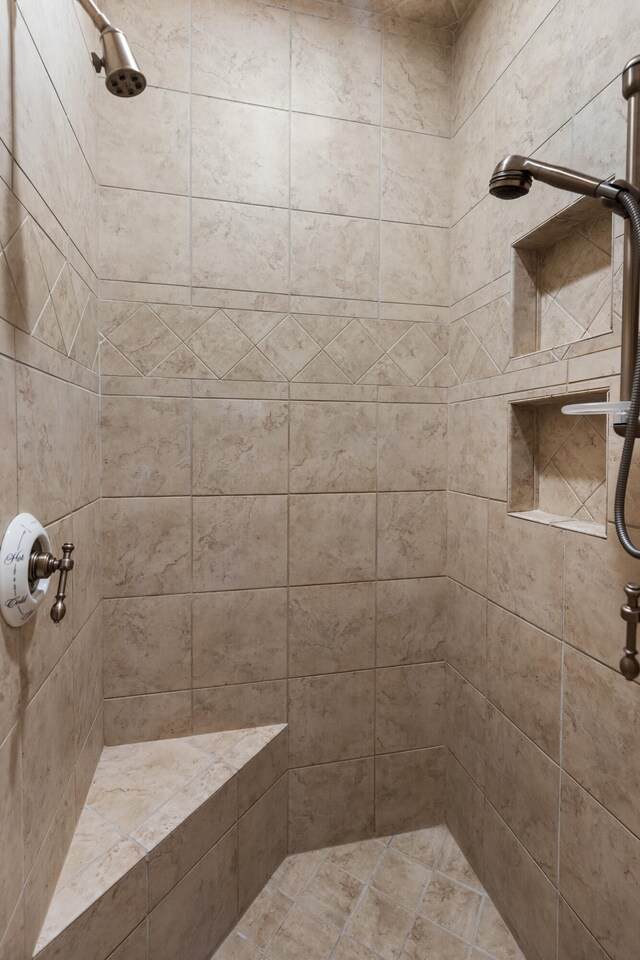 bathroom with a tile shower