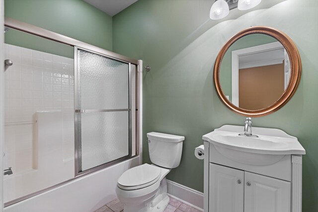 full bathroom with tile patterned floors, toilet, combined bath / shower with glass door, and vanity