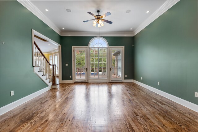 empty room featuring hardwood / wood-style floors, ceiling fan, and crown molding