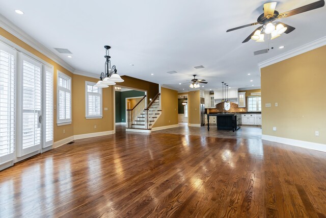 unfurnished living room with ceiling fan, dark hardwood / wood-style floors, and ornamental molding