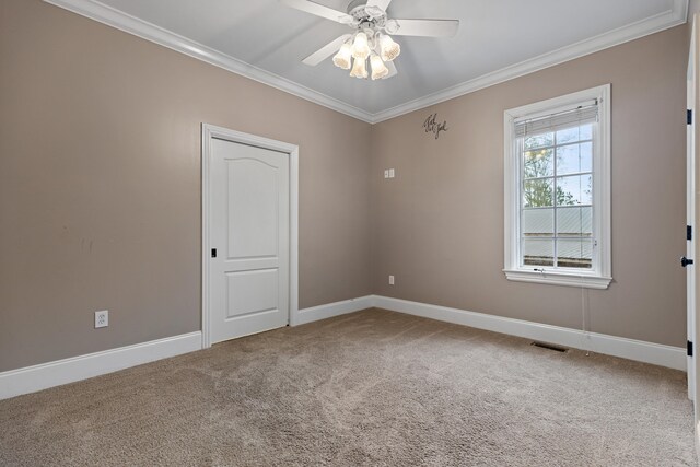 empty room with carpet floors, ceiling fan, and crown molding