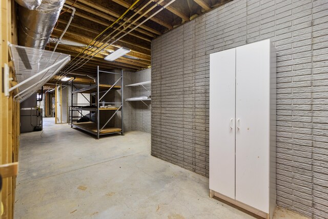 basement featuring brick wall