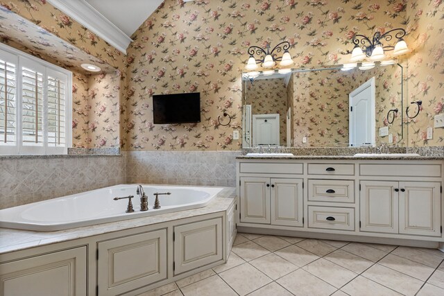 bathroom featuring tile patterned flooring, a bath, and vanity