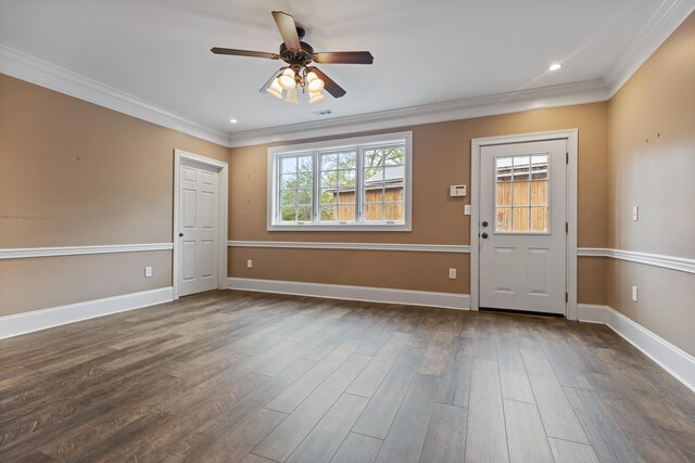 foyer entrance featuring dark hardwood / wood-style floors, plenty of natural light, and ornamental molding