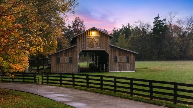 view of front facade with a lawn and an outbuilding