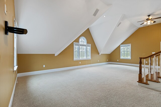 bonus room with light carpet, vaulted ceiling, and ceiling fan