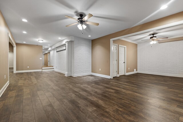 unfurnished living room with ceiling fan, dark hardwood / wood-style flooring, and brick wall