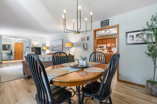 180 Mapleton Forest Dr NW, Cleveland, TN 37312 - dining space with light wood-style flooring and a chandelier