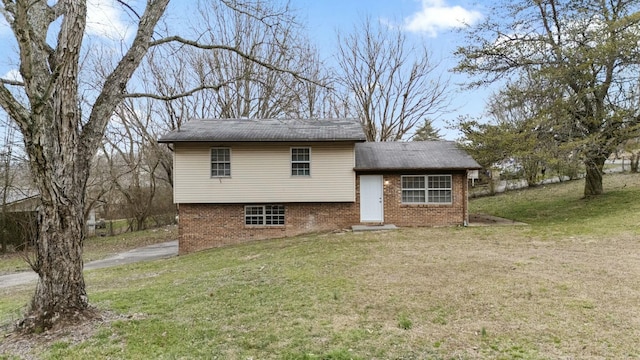 view of front of house with brick siding and a front yard