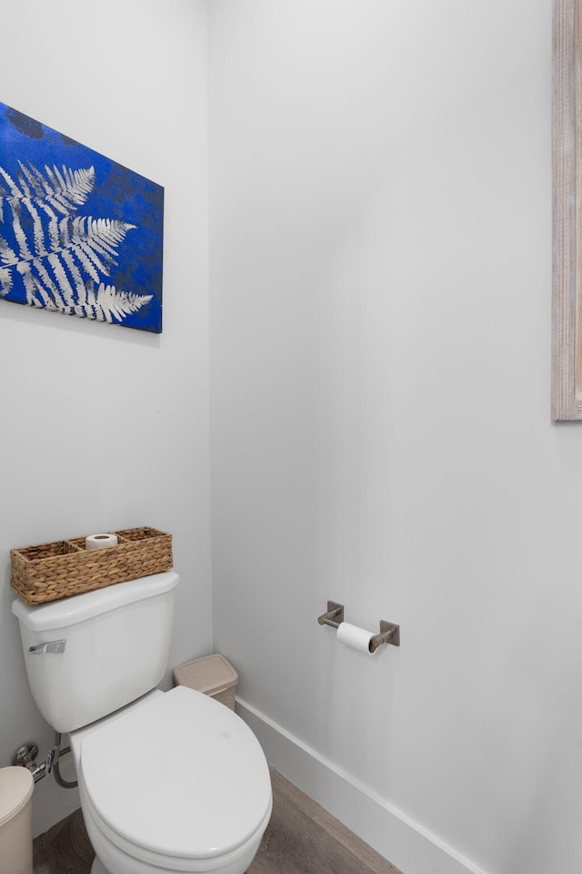 bathroom featuring wood-type flooring and toilet