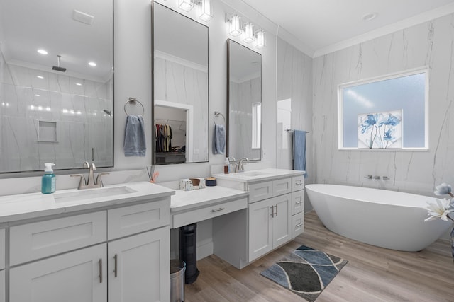 bathroom with hardwood / wood-style floors, vanity, crown molding, and independent shower and bath