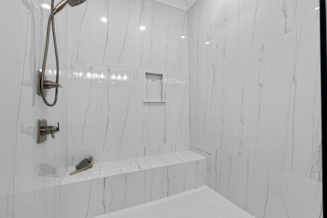 bathroom with a tile shower