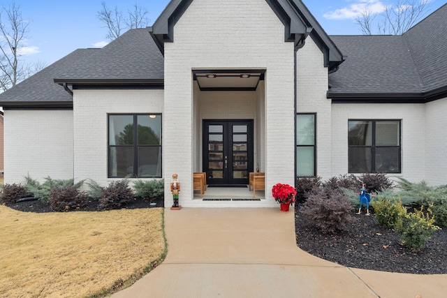 entrance to property with french doors and a yard